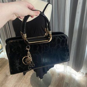 Black magnetic Handbag with gold accents
